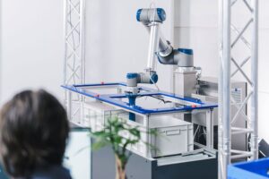 Employee working together with pick and place robot.