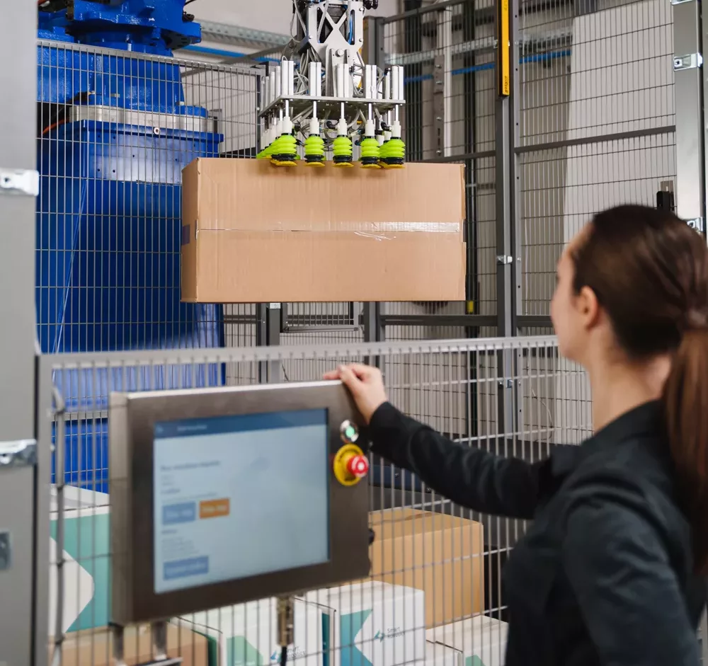 Operator watching the Smart Mixed Case Palletizer